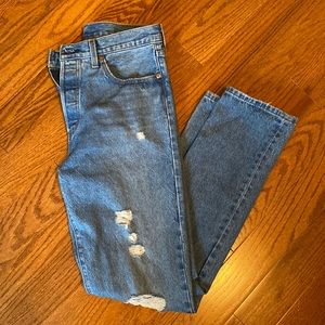 Levi’s 501 straight leg distressed blue jeans.